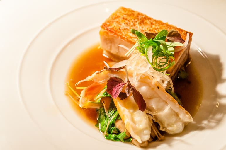 Crisp pork belly croustillant with scampi, squid ‘noodles’, at Lake House
